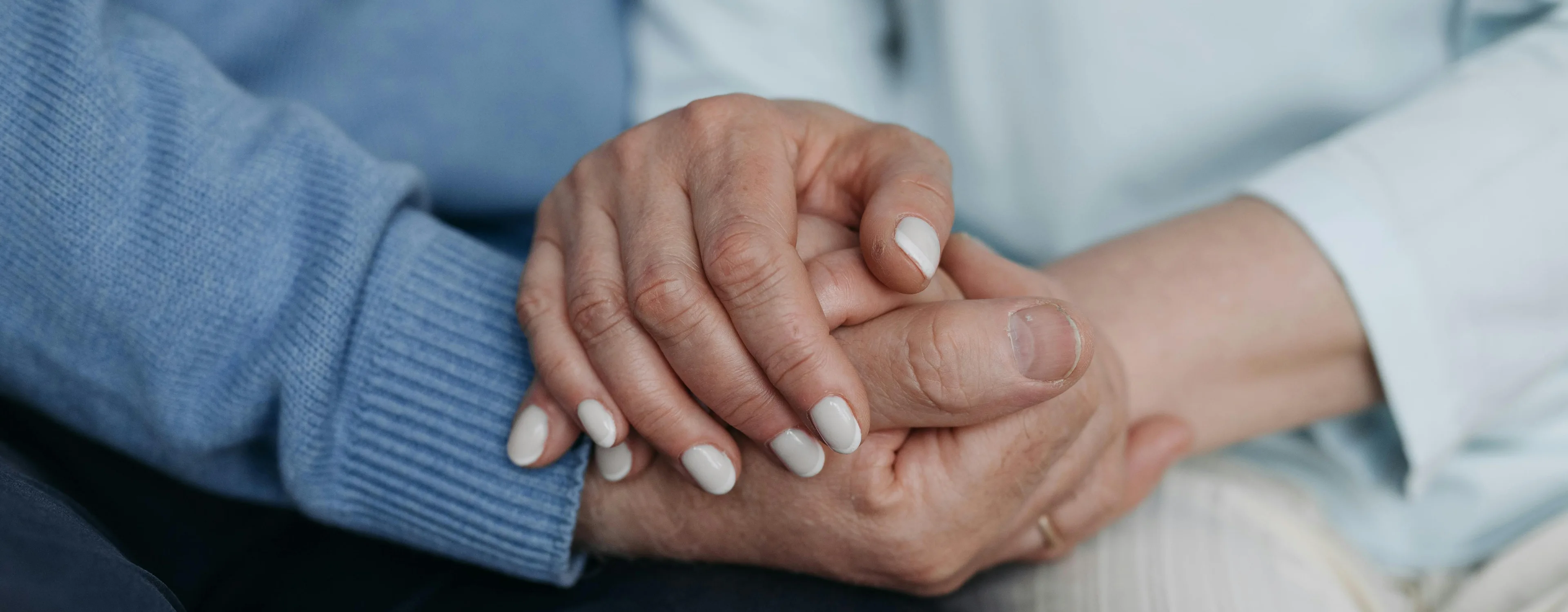 Two people holding hands